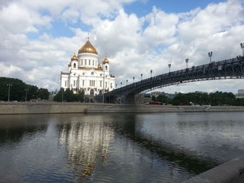 Patriarshy bridge over moskva river by cathedral of christ the saviour against sky