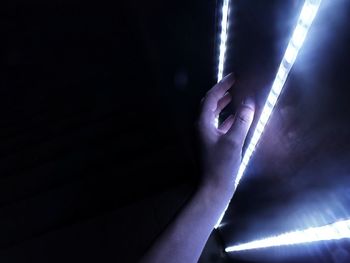 Close-up of hand holding illuminated light