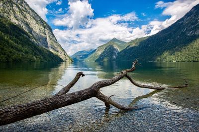 Scenic view of lake by mountains against sky