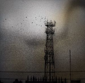 Low angle view of power lines against sky