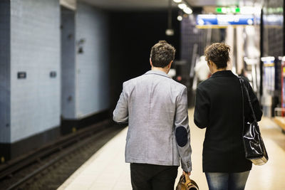 Rear view of business people waiting at subway station