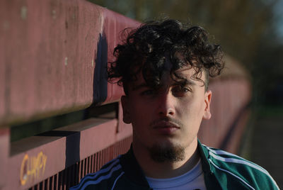 Portrait of young man looking away outdoors