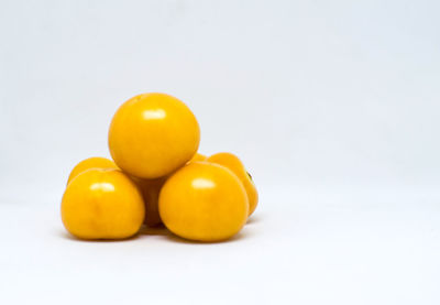 Close-up of yellow eggs against white background