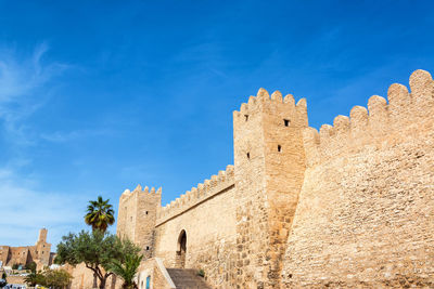 Low angle view of fort against blue sky