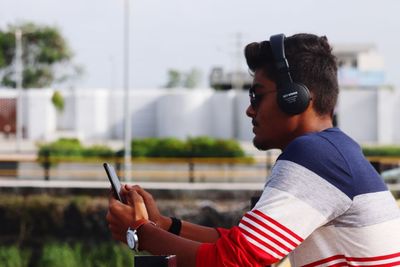 Portrait of young man using mobile phone