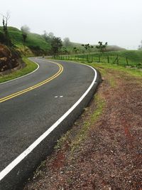 Road by landscape against clear sky