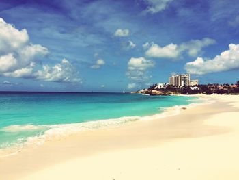 View of beach against cloudy sky