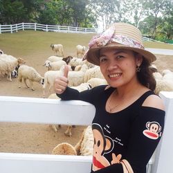 Portrait of smiling young woman with horse