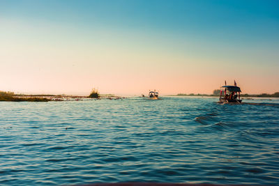 Scenic view of sea against clear sky during sunset