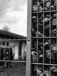 Close-up of metal grate against sky