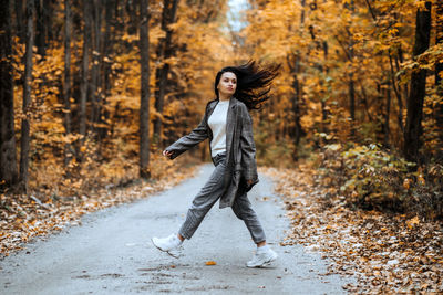 Autumn anxiety, mental health. happy brunette woman enjoy life in autumn forest