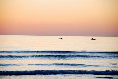 Scenic view of sea against clear sky during sunset