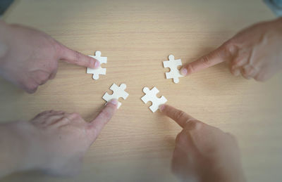 High angle view of people hands on table