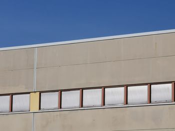 Low angle view of building against clear blue sky