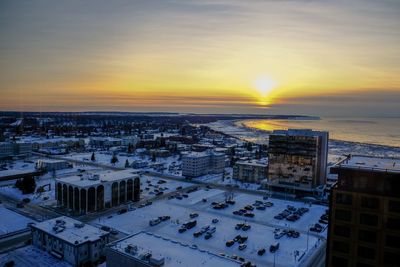 High angle view of buildings in city during sunset