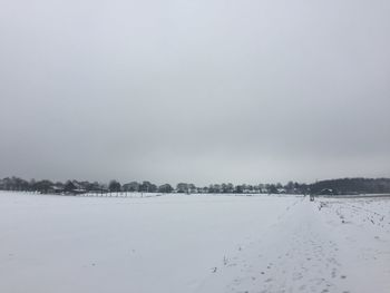 Scenic view of snow covered landscape against sky
