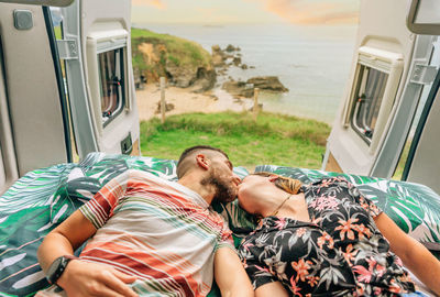Couple kissing while lying in motor home