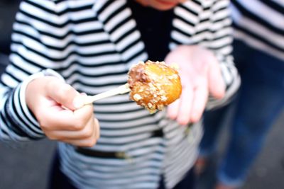 Midsection of woman holding food