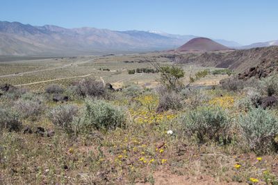 Scenic view of land and mountains against sky