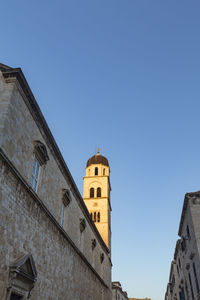 Low angle view of building against clear blue sky