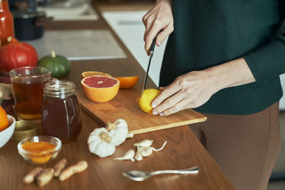 Midsection of woman preparing food on table