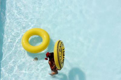 Woman holding life belt in pool