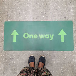 Low section of person with text on floor ,one way 