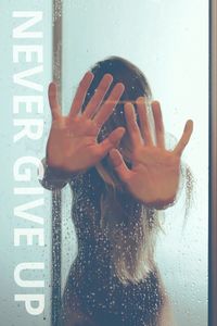 Midsection of woman on wet glass window