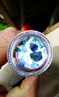 High angle view of hand holding crystal ball