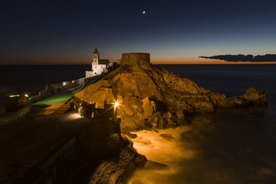 Scenic view of beach against sky at night