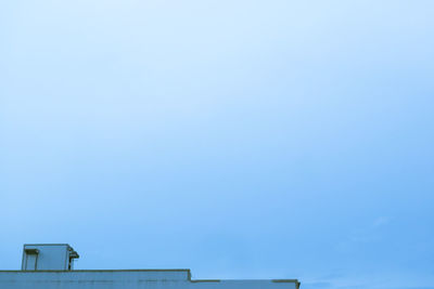 Low angle view of roof against clear blue sky