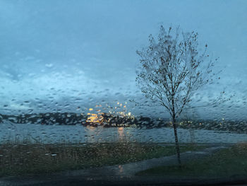 Close-up of wet glass window in rainy season