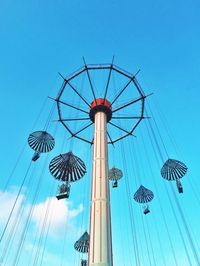 Low angle view of ferris wheel against blue sky