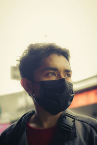 Portrait of young man covering face