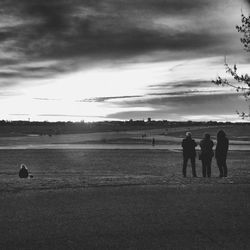 Silhouette of landscape against cloudy sky