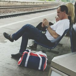 Full length of woman sitting on bench