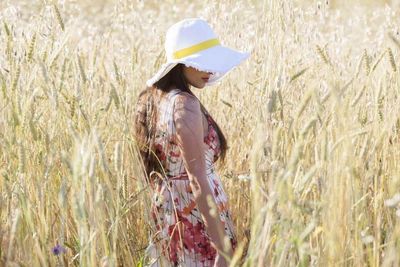 Side view of a woman standing in the field