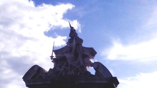 Low angle view of church against cloudy sky