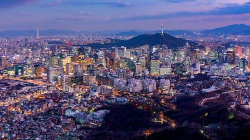 High angle view of illuminated cityscape against sky