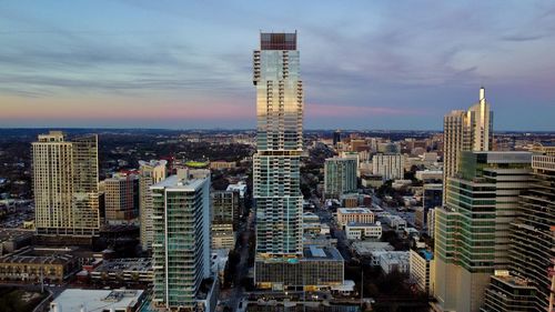 Austin cityscape against reflective sunset sky