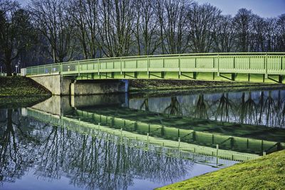 Bridge over river against sky during winter