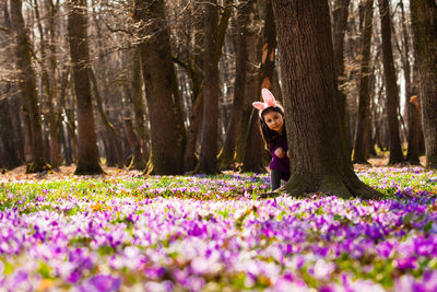 Person wearing purple flowers in forest