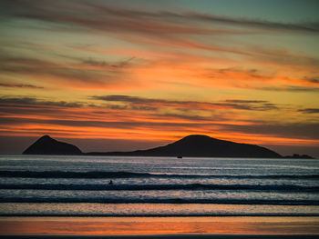 Scenic view of sea against orange sky