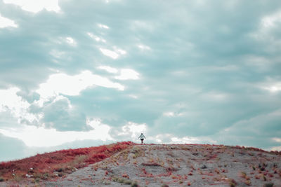 Low angle view of landscape against cloudy sky