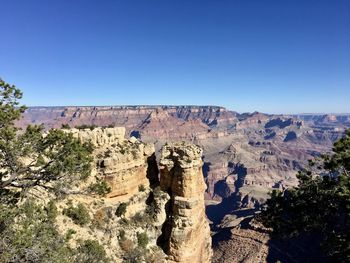 Scenic view of cliff against clear sky