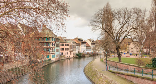 Canal amidst buildings against sky