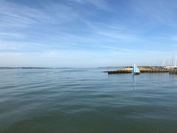 Sailboat in sea against sky