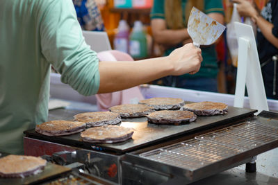 Midsection of man preparing food