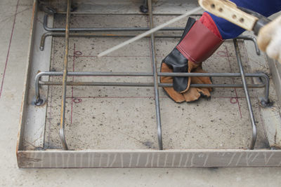 Low section of shoes at construction site