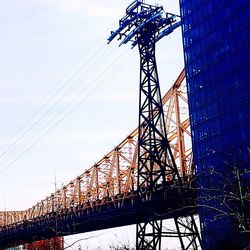 Low angle view of electricity pylon against sky